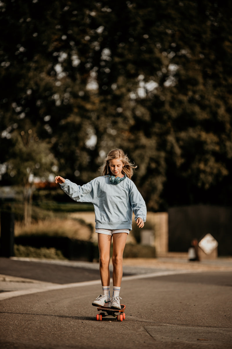 Girl on a skateboard with POGS